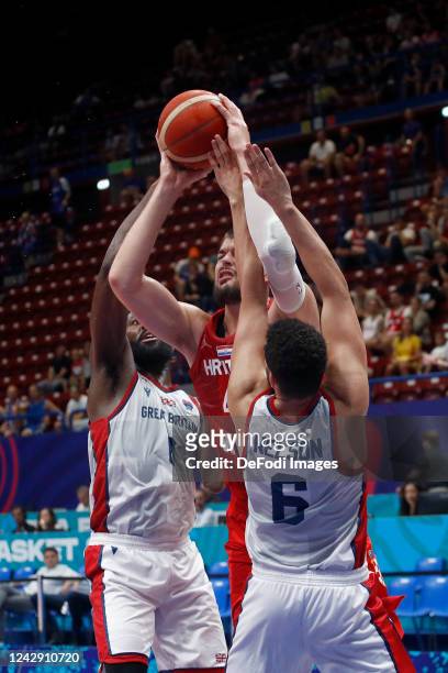 Gabriel Olaseni of Great Britain, Ivica Zubac of Croatia and Luke Nelson of Great Britain battle for the ball during the FIBA EuroBasket 2022 group C...