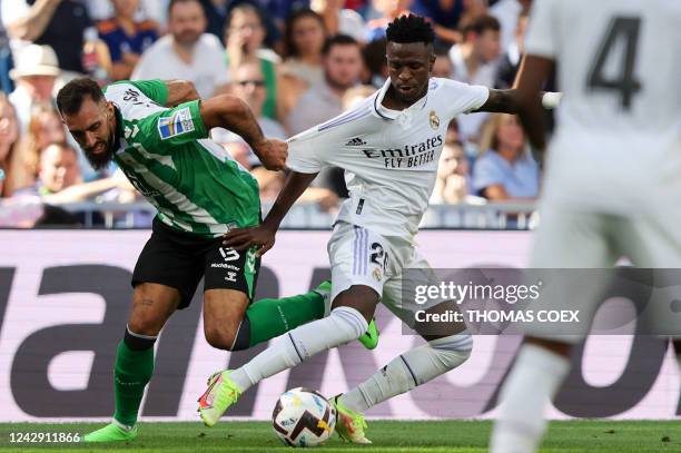 Real Betis' Spanish forward Borja Iglesias fights for the ball with Real Madrid's Brazilian forward Vinicius Junior during the Spanish league...