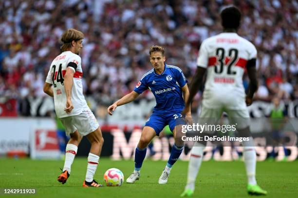 Borna Sosa of VfB Stuttgart, Cedric Brunner of FC Schalke 04 and Naouirou Ahamada of VfB Stuttgart battle for the ball during the Bundesliga match...