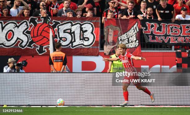 Freiburg's Japanese midfielder Ritsu Doan celebrates his 2-3 during the German first division Bundesliga football match between Bayer 04 Leverkusen...