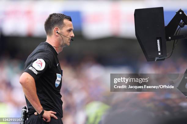 Andy Madley, the match referee looks at the VAR screen to disallow a second West Ham goal during the Premier League match between Chelsea FC and West...