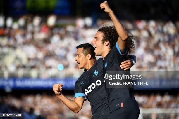 Marseille's Chilean forward Alexis Sanchez celebrates with Marseille's French midfielder Matteo Guendouzi after scoring his team's second goal during...