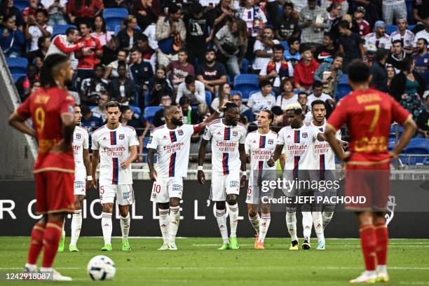 Lyons Cameroonian forward Karl Toko Ekambi celebrates with his teammates after scoring a goal during the French L1 football match between Olympique...