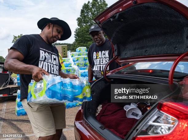 Residents distribute cases of water at Grove Park Community Center in Jackson, Mississippi, on September 3, 2022. - Jackson is enduring days without...