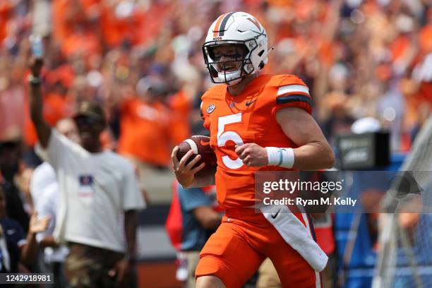 Brennan Armstrong of the Virginia Cavaliers rushes for a touchdown in the first half during a game against the Richmond Spiders at Scott Stadium on...