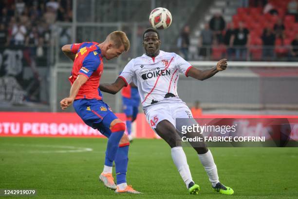 Sion's Italian forward Mario Balotelli fights for the ball with FC Basel's Spanish defender Arnau Comas during their Swiss super league football...