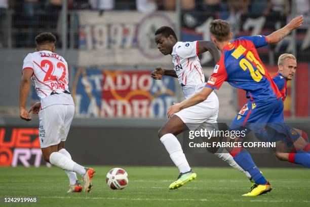 Sion's Italian forward Mario Balotelli controls the ball next to FC Basel's Dutch midfielder Wouter Burger with during their Swiss super league...