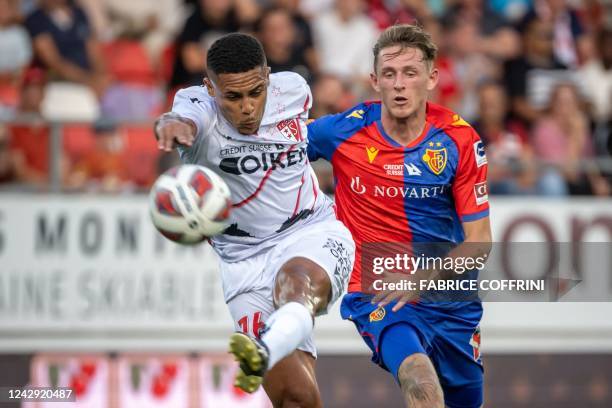 Basel's Swiss goalkeeper Nils de Mol vies FC Basel's Dutch midfielder Wouter Burger with during their Swiss super league football match FC Sion...