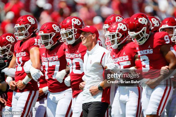 Head coach Brent Venables of the Oklahoma Sooners walks arm in arm with his team before a game against the UTEP Miners at Gaylord Family Oklahoma...
