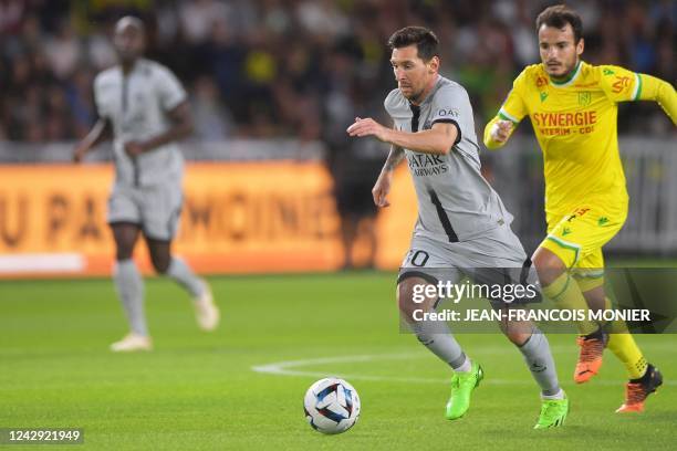 Paris Saint-Germain's Argentinian forward Lionel Messi runs with the ball during the French L1 football match between FC Nantes and Paris...