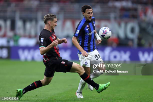 Matteo Darmian of FC Internazionale and Alexis Saelemaekers of AC Milan battle for the ball during the Serie A match between AC Milan and FC...