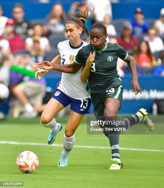 Forward Alex Morgan and Nigeria's midfielder Christy Ucheibe vie for the ball during their women's international friendly football match between the...