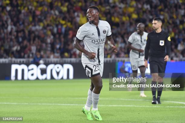 Paris Saint-Germain's Portuguese defender Nuno Mendes celebrates after scoring his team's third goal during the French L1 football match between FC...