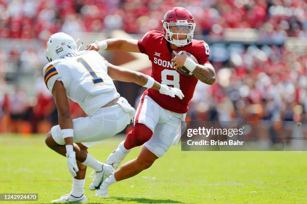 Quarterback Dillon Gabriel of the Oklahoma Sooners cuts back past safety Tyson Wilson of the UTEP Miners to score a 12-yard touchdown in the first...