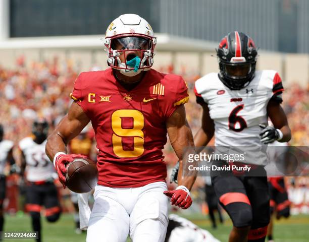 Wide receiver Xavier Hutchinson of the Iowa State Cyclones celebrates after scoring a touchdown as defensive back William McCall of the Southeast...