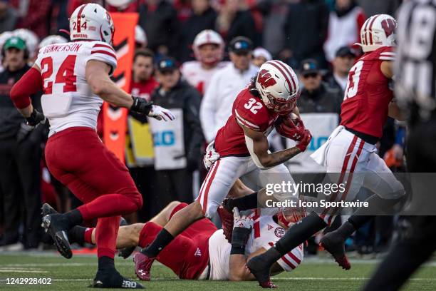 Wisconsin Badgers running back Julius Davis gets tackled by a Nebraska defender durning a college football game between the Nebraska Cornhuskers and...