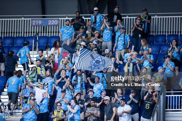 Supporters fo Philadelphia Union in the stands wave flags and wear blue to show their support before the Major League Soccer match against New York...