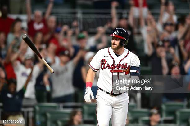 Robbie Grossman of the Atlanta Braves tosses his bat after taking a walk to win the game against the Miami Marlins during the ninth inning at Truist...
