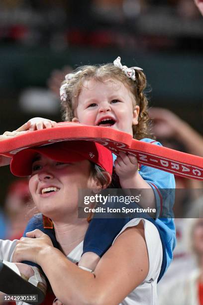 Young fan enjoys time sitting on her mothers shoulders during a game between the Chicago Cubs and the St. Louis Cardinals on Sep 03 at Busch Stadium...