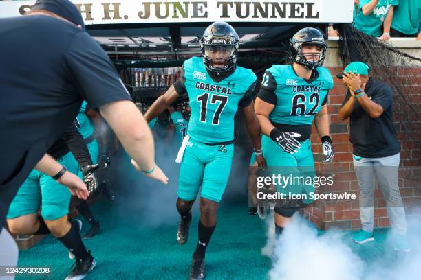 Kaleb Hutchinson of the Coastal Carolina Chanticleers runs on to the field before a football game between the Coastal Carolina Chanticleers and the...