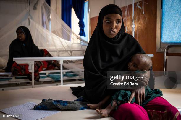 Malnourished baby is held by their mother as Martin Griffiths, Under Secretary General for the United Nations Humanitarian Affairs and Emergency...