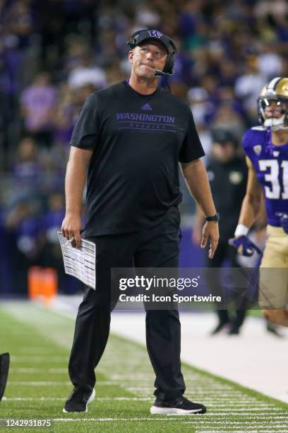 Washington Huskies head coach Kalen DeBoer looks at the video board during a college football game between the Kent State Golden Flashes and the...