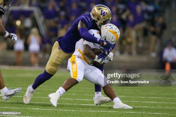 Washington Huskies linebacker Alphonzo Tuputala tackles Kent State Golden Flashes running back Marquez Cooper during a college football game between...