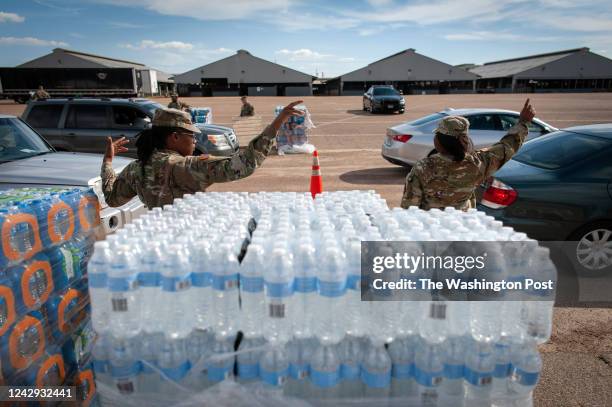 September 1: Mississippi National Guard members direct traffic at a water distribution site at the Mississippi State Fairgrounds in Jackson,...