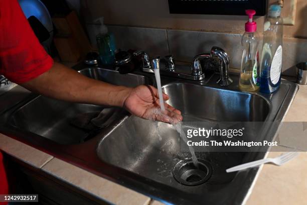 Timbo Payne checks the water pressure in his kitchen at his home on September 3, 2022 in Jackson, Mississippi. The entire city of Jackson has been...