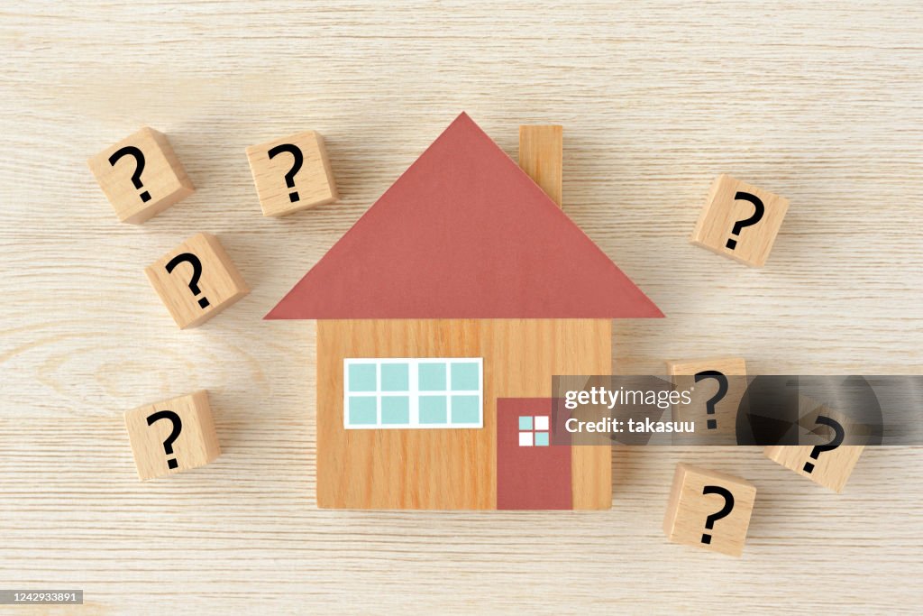 House object and wooden blocks with question mark