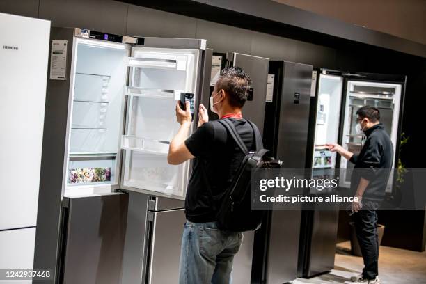 September 2022, Berlin: Visitors look at refrigerators at the electronics fair IFA. More than 1100 exhibitors show the novelties of consumer...