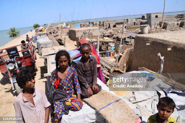 Displaced people start to live at makeshift camps after the flood hit their homes due to heavy monsoon rains as flooded area is seen in Sewan Sharif,...