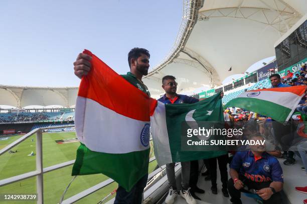 Fans pose holding India and Pakistan's national flags as they wait for the start of the Asia Cup Twenty20 international cricket Super Four match...