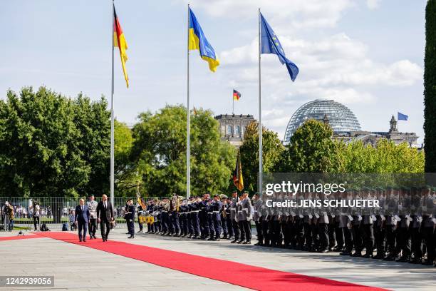 German Chancellor Olaf Scholz and Ukraine's Prime Minister Denys Shmyhal inspect a military honor guard in the courtyard of the Chancellery in Berlin...