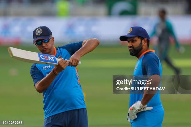India's captain Rohit Sharma speaks with team coach Rahul Dravid before the start of the Asia Cup Twenty20 international cricket Super Four match...