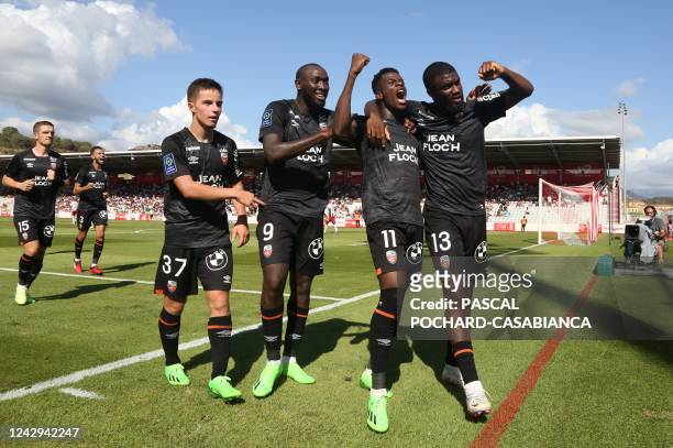 Lorient's Burkinabe forward Dango Ouattara celebrates with teammates after scoring a goal during the French L1 football match between AC Ajaccio and...