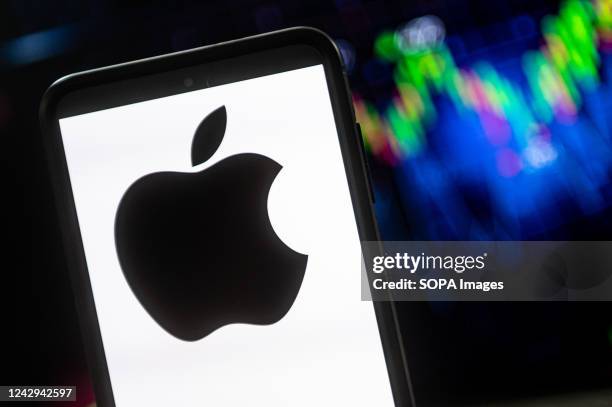 In this photo illustration a Apple logo seen displayed on a smartphone.