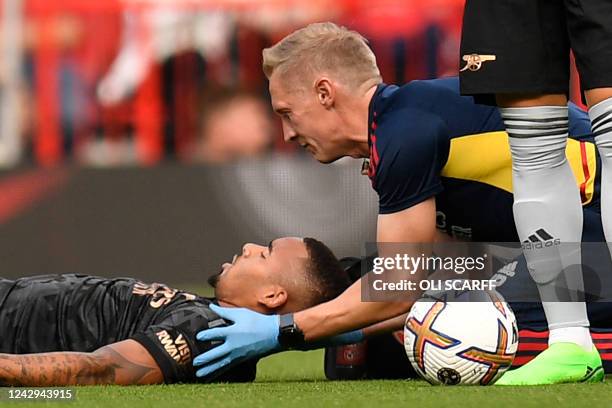 Arsenal's Brazilian striker Gabriel Jesus is treated for a head injury during the English Premier League football match between Manchester United and...