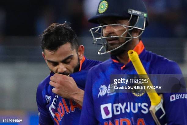 India's Virat Kohli kisses his jersey after scoring a half-century during the Asia Cup Twenty20 international cricket Super Four match between India...
