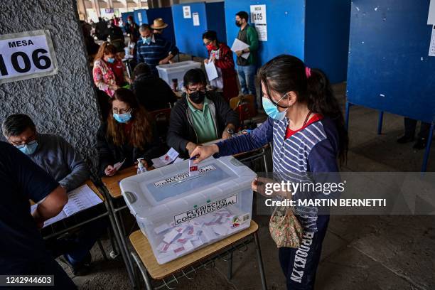 Woman casts her vote during a referendum to approve or reject a new Constitution at a polling station in Santiago, on September 4, 2022. - More than...