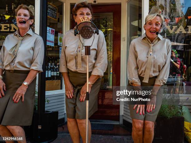 Group of women dressing in vintage clothes is singing old songs, during the Airborne walking march held around Oosterbeek, on September 3rd, 2022.