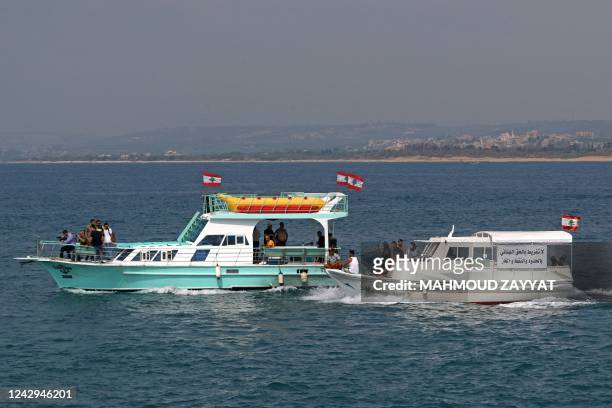 Lebanese protesters take part in a rally by sailing in boats with slogans in Arabic affirming Lebanon's right to its offshore gas wealth, from the...