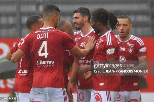 Brest's French midfielder Pierre Lees-Melou celebrates with teammates after scoring his team's first goal during the French L1 football match between...