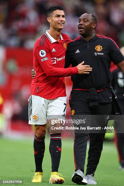 Cristiano Ronaldo of Manchester United celebrates the 3-1 victory with Benni McCarthy the First Team Coach during the Premier League match between...