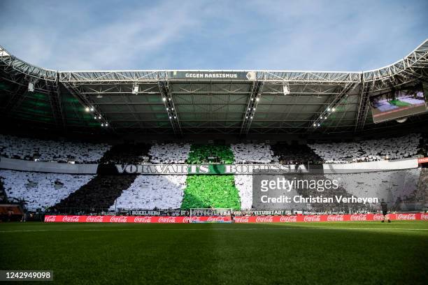 Fans of Borussia Moenchengladbach show a choreography with banners and papers ahead of the Bundesliga match between Borussia Moenchengladbach and...
