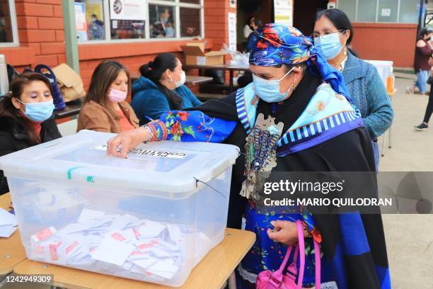 Mapuche woman casts her vote during a referendum to approve or reject a new Constitution at a polling station in Temuco, Chile, on September 4, 2022....