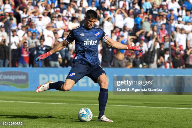 Sergio Rochet, goalkeeper of Nacional, kicks the ball during a match between Nacional and Peñarol as part of Torneo Clausura 2022 at Gran Parque...