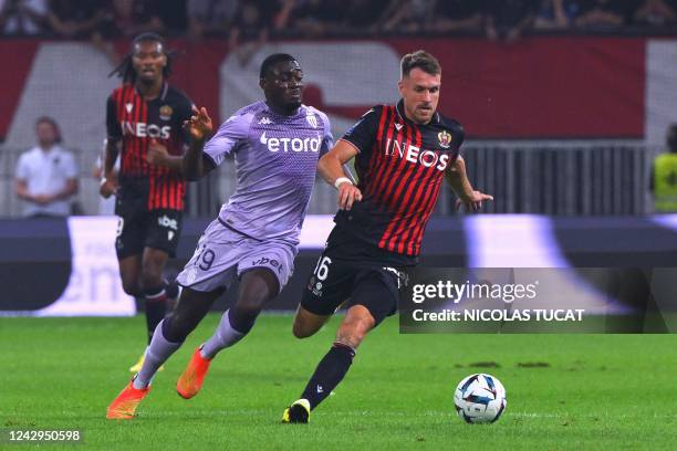 Nice's Welsh midfielder Aaron Ramsey fights for the ball with Monaco's French midfielder Youssouf Fofana during the French L1 football match between...