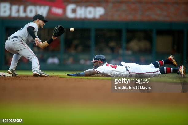 Charles Leblanc of the Miami Marlins tags out Atlanta Braves Michael Harris II of the Atlanta Braves on a steal attempt in the sixth inning at Truist...