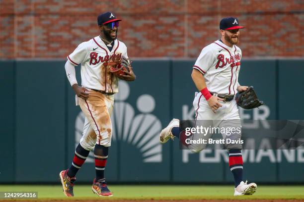 Michael Harris II and Robbie Grossman of the Atlanta Braves celebrate after a victory against the Miami Marlins at Truist Park on September 4, 2022...